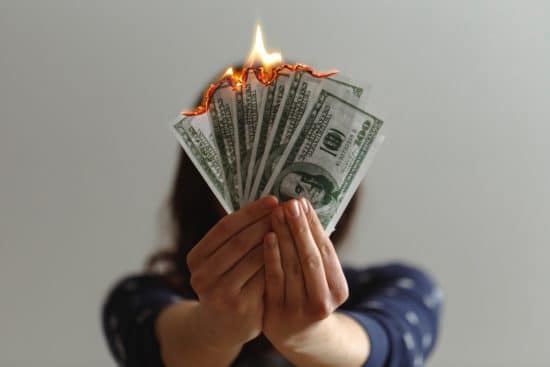 A person burning money.