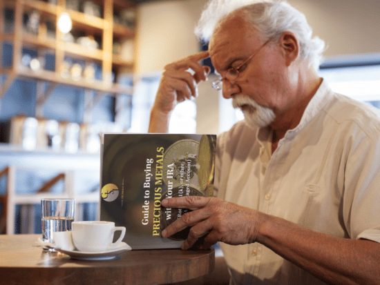 elder-man-reading-guide-buying-precious-metals-ira