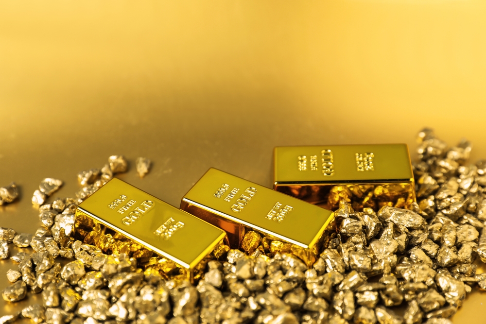 Gold,Nuggets,And,Bars,On,Shiny,Background,,Closeup