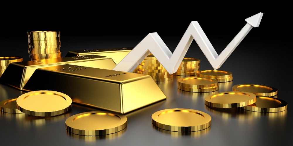 Gold bars and coins arranged with a white upward trending arrow chart against dark background