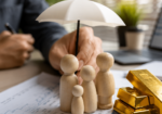 Gold bars beside financial documents illustrating the gold price outlook as strong economic data pressures precious metals.
