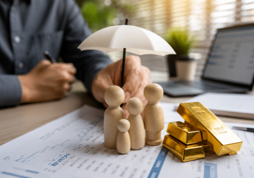 Gold bars beside financial documents illustrating the gold price outlook as strong economic data pressures precious metals.