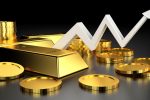 Gold bars and coins arranged with a white upward trending arrow chart against dark background